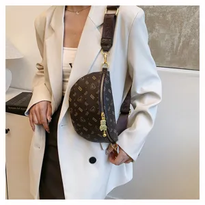 Detailed view of fashionable brown monogram chest bag with adjustable strap and chic bear pendant.