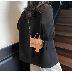 Detailed view of women retro contrast color mini crossbody bag with chain strap and pendant.