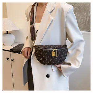 Stylish brown monogram chest bag with cute bear pendant for women and daily wear.