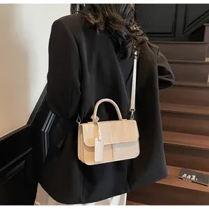 Close-up detail of the stylish color-blocked handbag showing exquisite stitching and hardware.