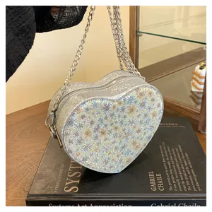Stylish heart-shaped crossbody bag with glitter floral finish and chic chain strap for women.