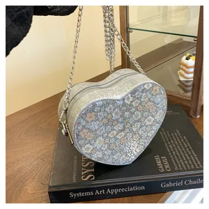 Silver glitter heart-shaped chain shoulder bag, stylish floral crossbody bag for women.