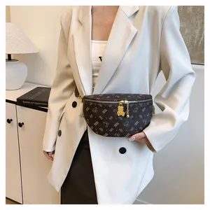 Detailed view of the stylish monogram chest bag featuring bear print and gold chain accent.
