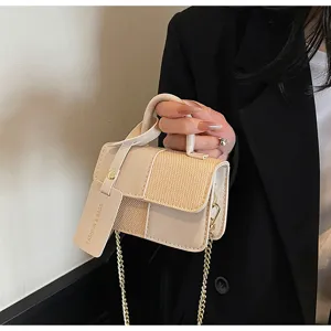 Chic contrast-color woven small handbag detail, featuring elegant chain strap and retro design.