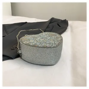 Stylish heart-shaped floral chain crossbody bag for women, chic silver glitter underarm bag.