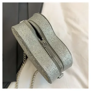 Silver glitter heart-shaped chain crossbody bag detail view, stylish fashion handbag for women.