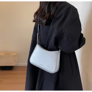 Retro women shoulder bag minimalist design baguette bag detail view showing metallic finish.