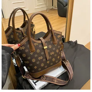 Stylish retro brown monogram bucket bag with top handle and wide canvas crossbody strap.