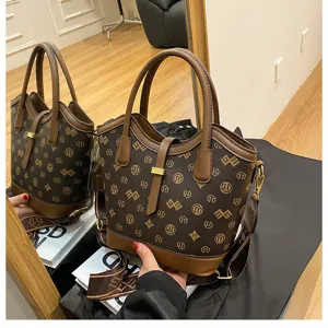 Retro brown monogram bucket bag for women, stylish PU leather shoulder crossbody bag with handle.