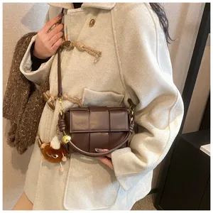 Brown woven leather crossbody shoulder bag with stylish intrecciato pattern and metal detail.