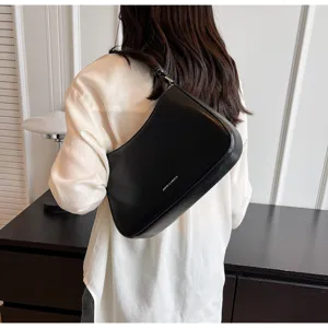 Black retro leather baguette shoulder bag for women, elegant daily accessory detail shot.