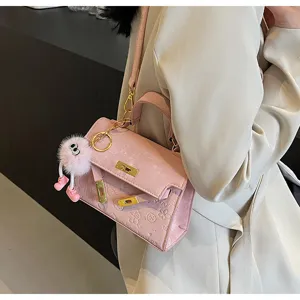 Pink embossed Kelly shoulder bag for women, stylish niche design handbag with cute pendant.