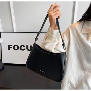 Classic black leather underarm shoulder bag, trendy minimalist retro baguette design for women.