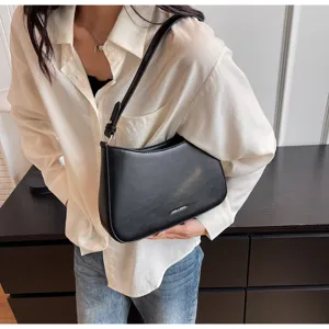 Detailed view of the black retro leather baguette shoulder bag, stylish underarm design.