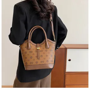 Retro brown monogram bucket bag detail shot showcasing classic leather texture and hardware.