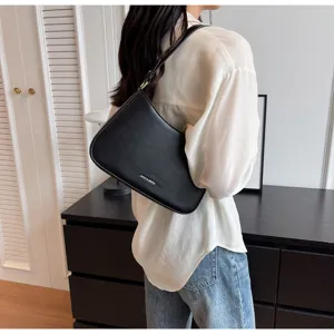 Vintage black baguette bag for women, stylish minimalist underarm shoulder bag with metal accent.