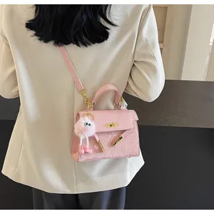 Pink Kelly shoulder bag for women with embossed pattern and cute plush keychain accessory
