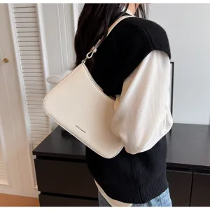 White underarm bag detail view, minimalist leather shoulder baguette bag for daily style.