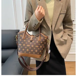 Close-up detail of retro brown monogram bucket bag, luxury style handle and shoulder strap.