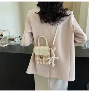 Chic argyle checkered mini crossbody bag for women, stylish phone bag with cute bunny pendant.
