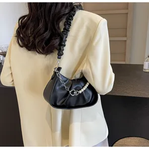 Detailed view of women black ruched shoulder bag with pearl metal chain strap, chic design.