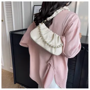 Detailed view of white gathered shoulder bag with pearl chain strap, trendy and versatile.