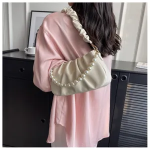 White ruched underarm bag with pearl chain detail, stylish cloud handbag for women detail shot.