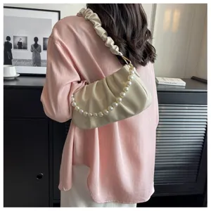 Detailed view of women pleated cloud handbag featuring elegant pearl chain and soft design.