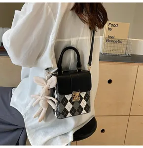 Chic black and white argyle crossbody bag with top handle, metal lock and cute bunny plush charm.