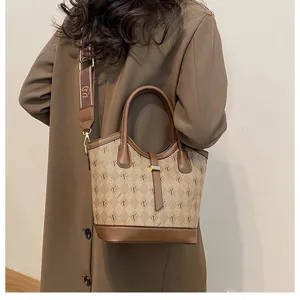 Retro fashion bucket bag for women, large capacity shoulder crossbody tote handbag with vintage monogram print.