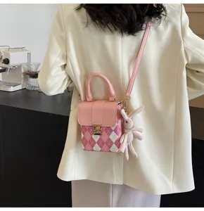 Chic pink argyle crossbody bag with cute rabbit pendant, stylish mini square phone purse.