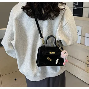Korean style black shoulder crossbody handbag for women, elegant Kelly bag with cute plush furry charm.