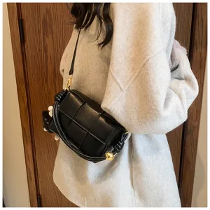 Black woven leather shoulder bag with chic metal ball knot design for women winter style.