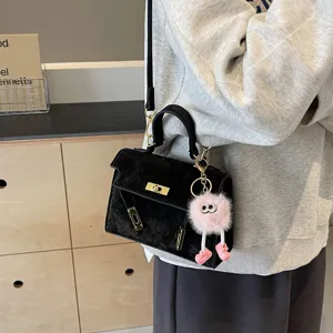 Black suede embossed Kelly bag for women, chic shoulder crossbody bag with cute fluffy plush charm.