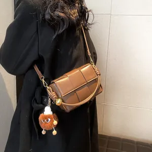 Fashion woven shoulder bag for women, stylish crossbody leather purse with cute fluffy pendant.
