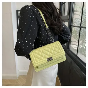 Chic light green quilted crossbody bag with metal chain strap and elegant turn-lock closure.