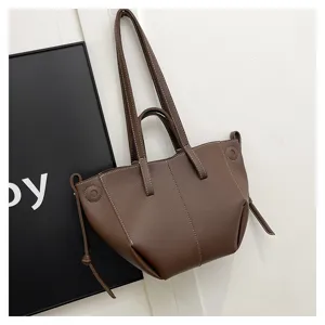 Stylish brown leather tote bag for women, large capacity shoulder handbag with dual handles.