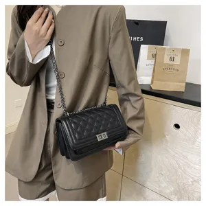 Black quilted chain shoulder bag detail showcasing premium leather texture and metal turn-lock.