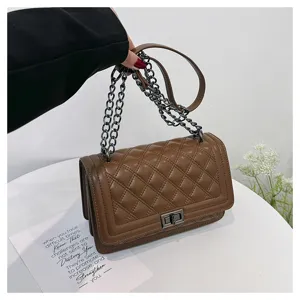 Brown quilted chain crossbody bag detail showing premium PU leather and vintage square lock.