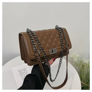 Brown quilted shoulder bag detail, elegant chain strap and metal lock design for women.