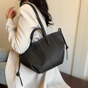 Black leather tote bag for women, versatile casual shoulder bag with contrast stitching design.