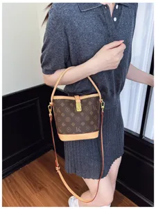 Detailed view of the vintage monogram bucket bag with chic golden lock and leather strap.