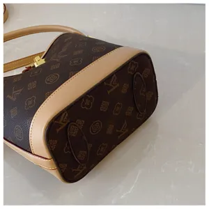 Detailed close-up view of vintage monogram bucket bag bottom and premium leather trim.