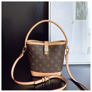 Vintage monogram bucket bag with top handle and shoulder strap for women classic handbag.