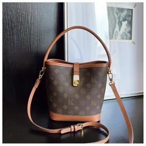 Retro monogram bucket bag detail, featuring brown PU leather trim and chic gold tone hardware.
