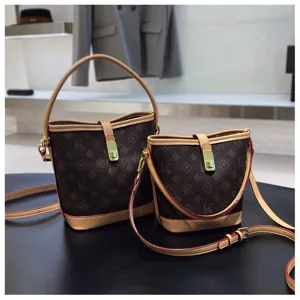 Vintage monogram bucket bag for women, luxury PU leather handbag with shoulder strap and lock.