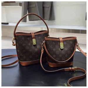 Vintage monogram print bucket bag detail showing premium leather trim and metal lock closure.