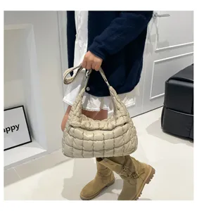 Close-up of stylish beige quilted puffer shoulder bag, soft cloud crossbody bag details.