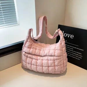 Pink quilted puffer shoulder bag, cloud crossbody bag with adjustable strap and zip pocket.