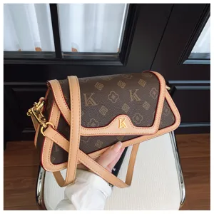 Fashion monogram shoulder bag for women, chic underarm design with contrast trim and gold K logo.